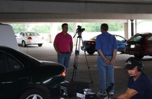 Craig N9ETD interviews with WXOW TV19 while Dave WV9E racks up the points in the foreground