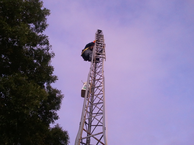 N9ETD Craig, going up the Self Support tower. The Ladder is all we could make work on the tower for a Gin Pole.